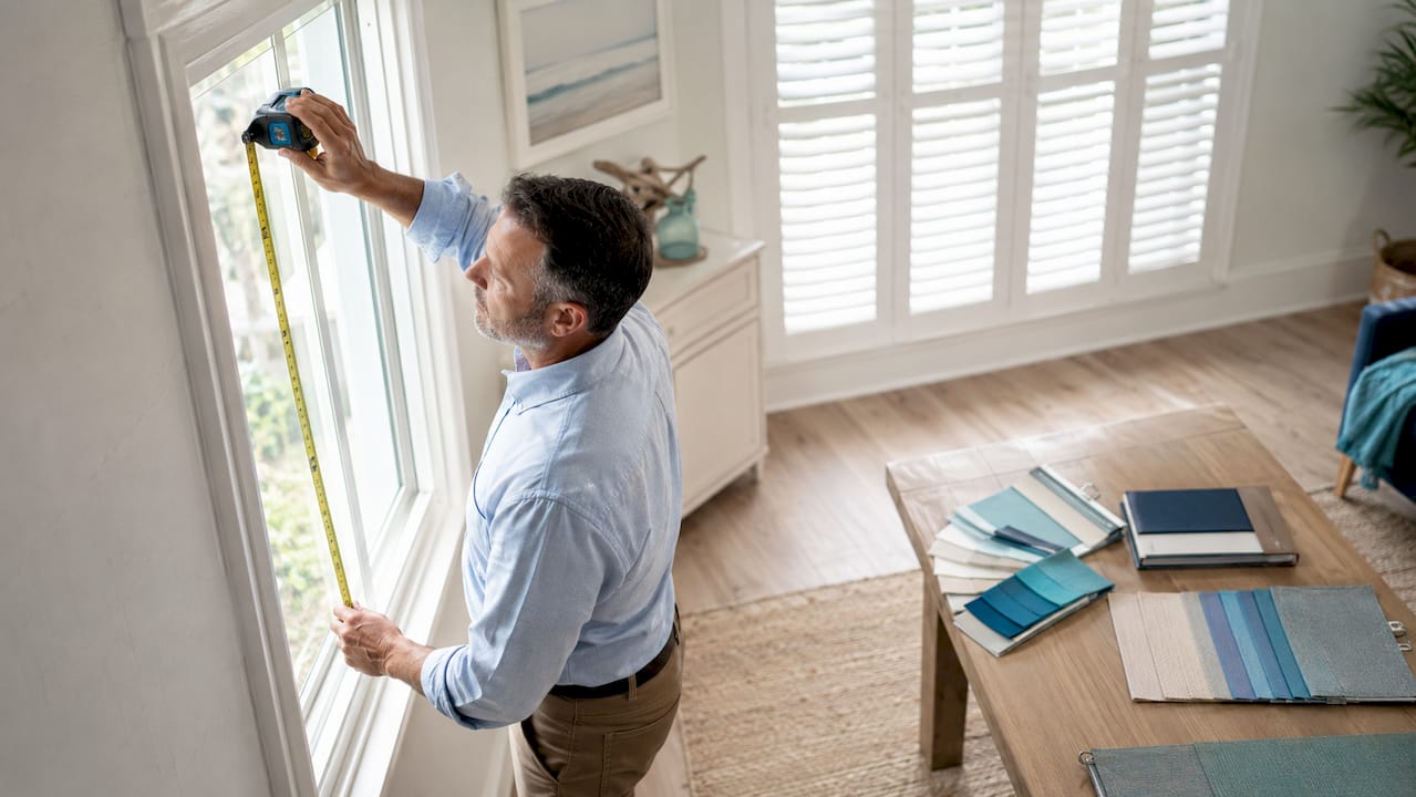 Window treatment expert measuring window in home