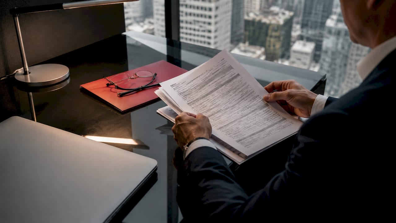 Hands reviewing mortgage disclosure document