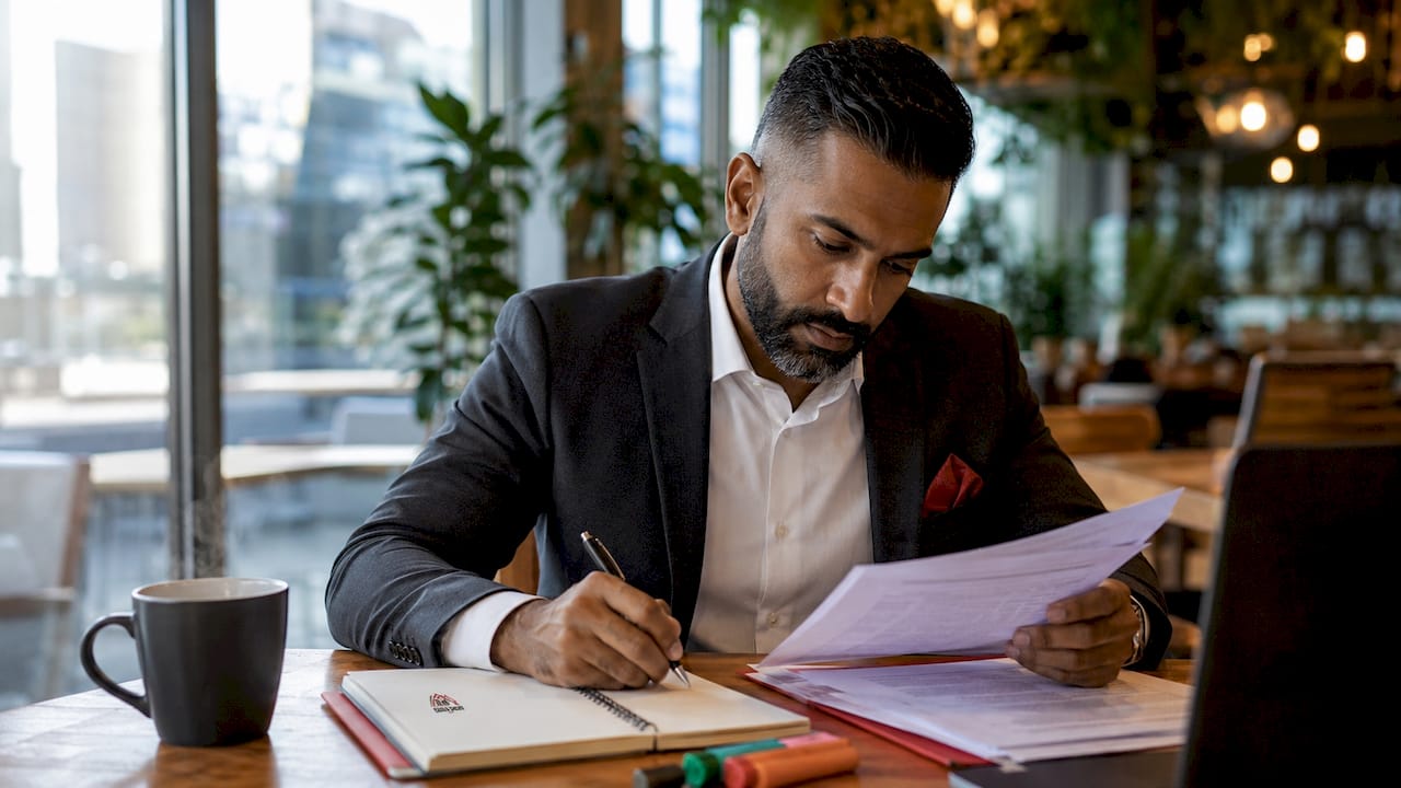 Mortgage broker reviewing lender offers at desk