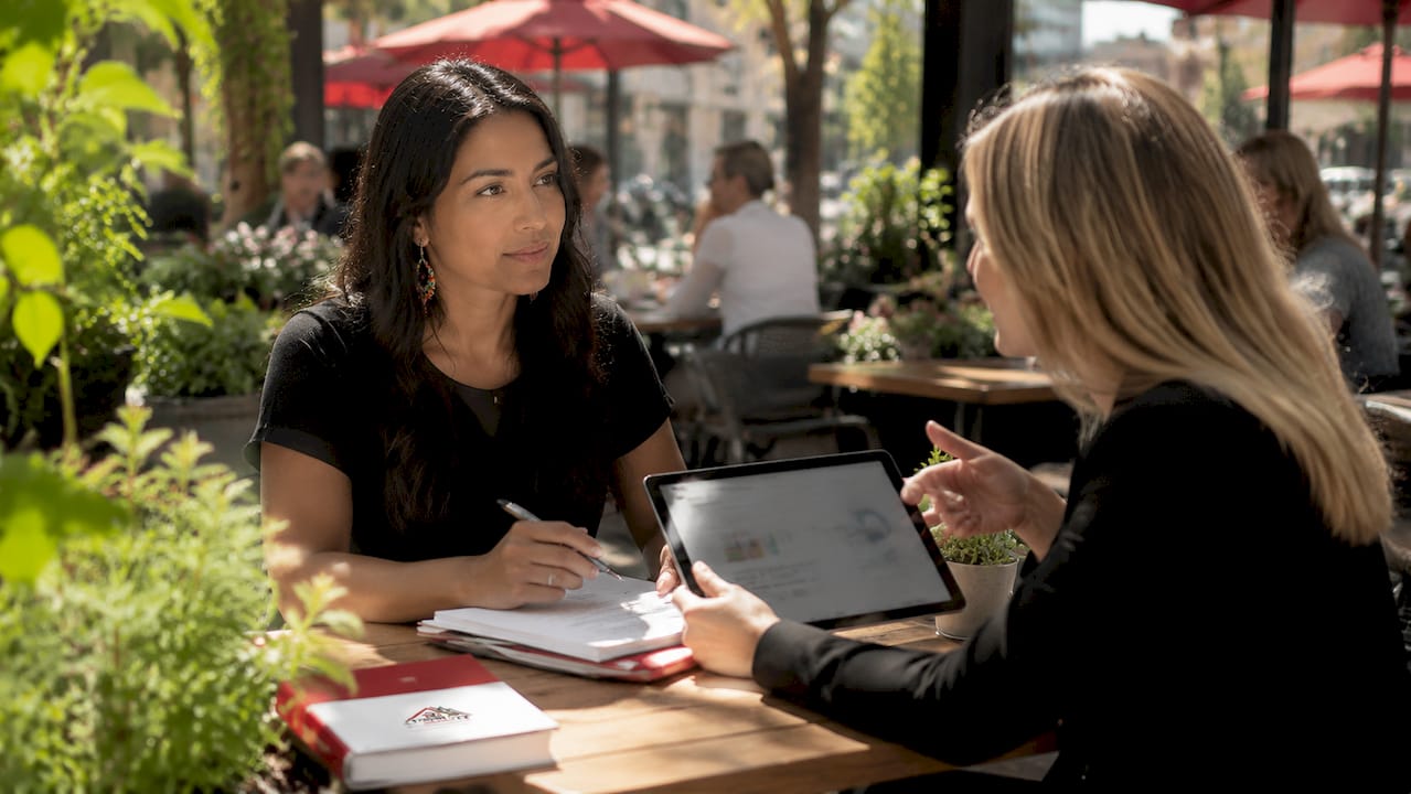 FIRST TIME HOME BUYER INCENTIVES: CALGARY AND EDMONTON GUIDE 1 Woman discussing home savings account with advisor