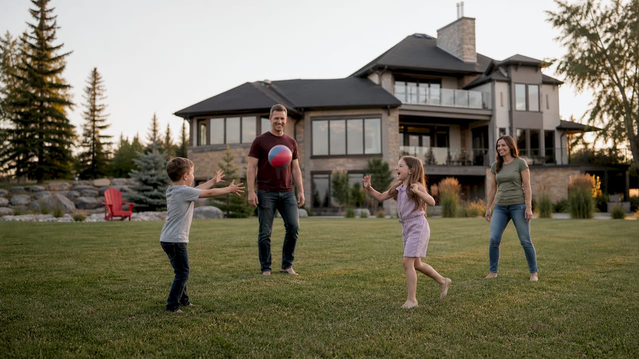 Family playing catch on luxury acreage lawn