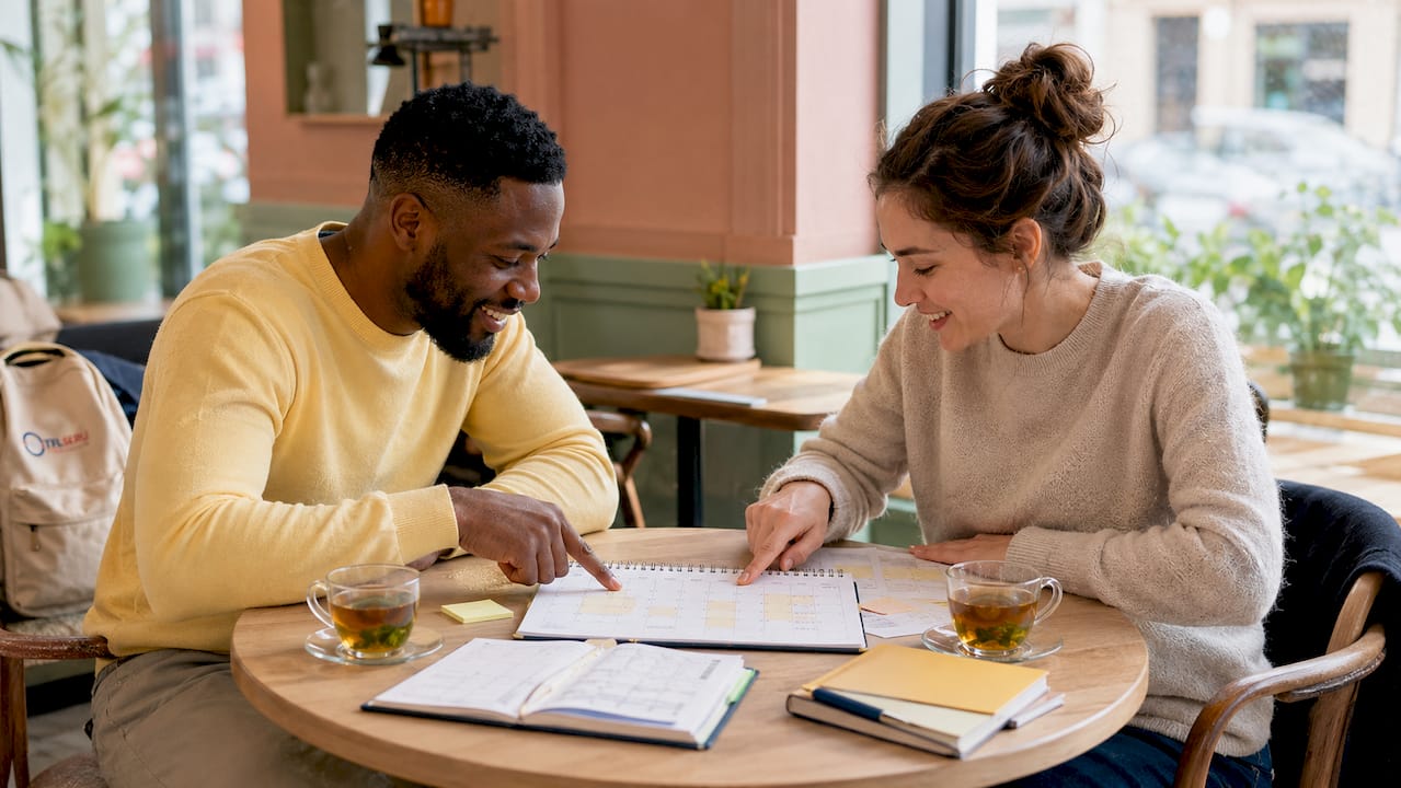Two people planning test appointment at desk