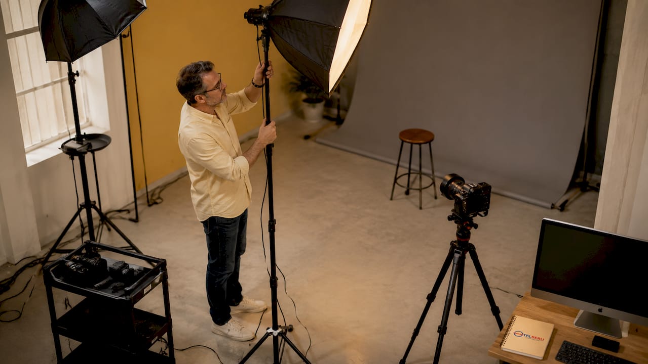 Photographer setting up UK passport photo studio