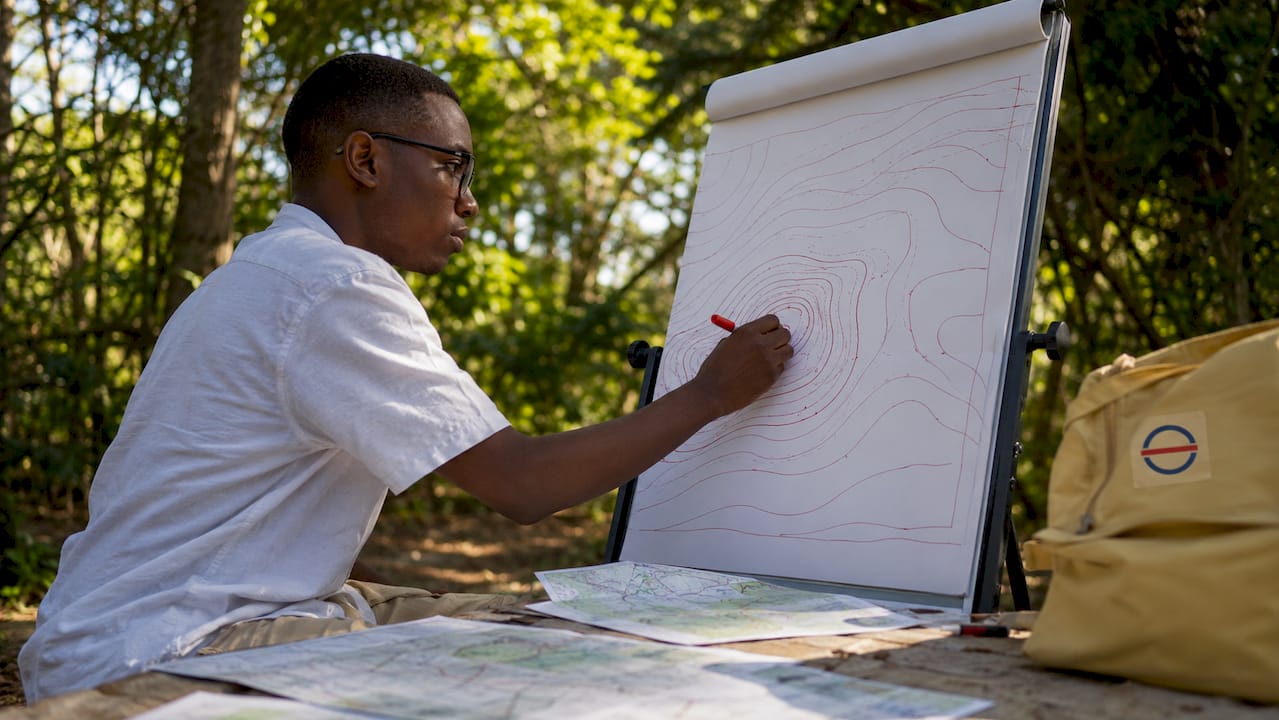 Man drawing contour lines in classroom