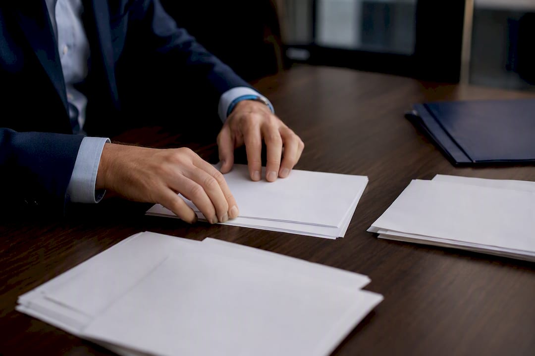 Hands reconciling financial documents