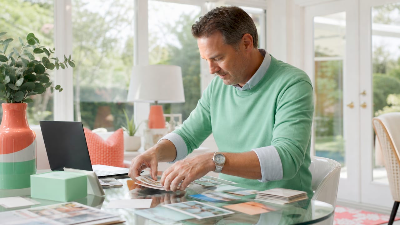 Hands organizing postcards for mailing schedule