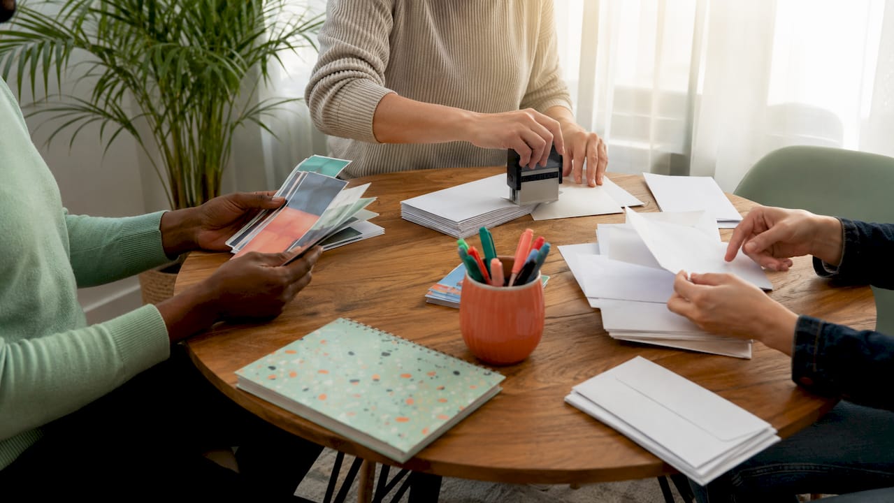 Hands preparing manual direct mail campaign
