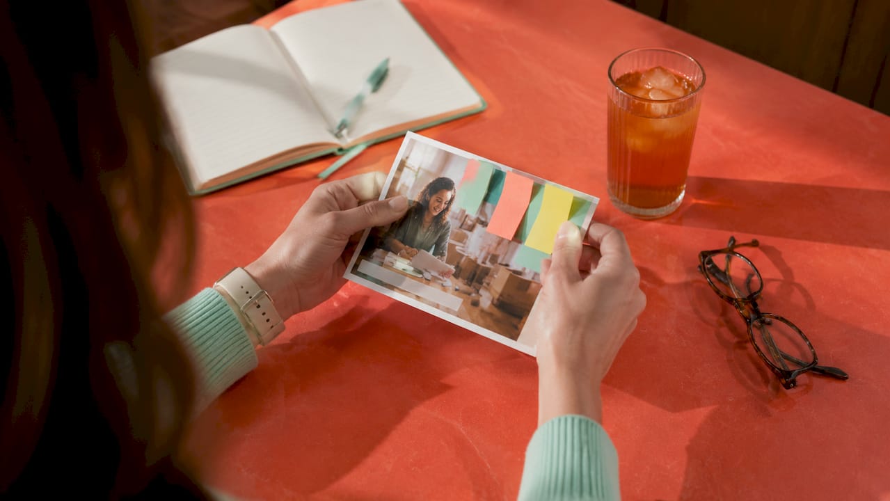 Hands reviewing direct mail postcard headline