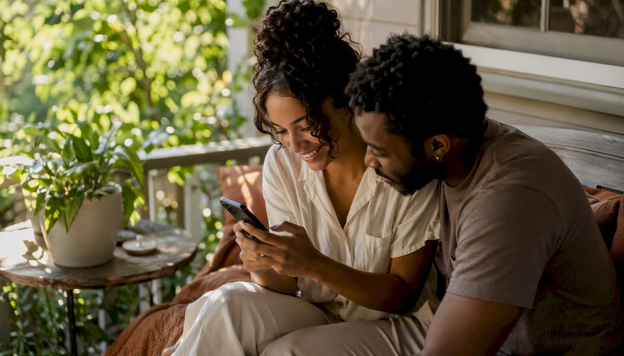 Couple sharing thoughtful automated message on phone