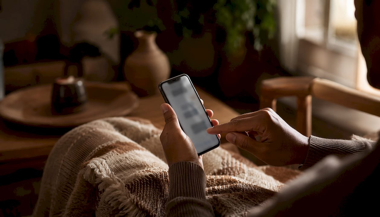 Hands sending affectionate message via phone app