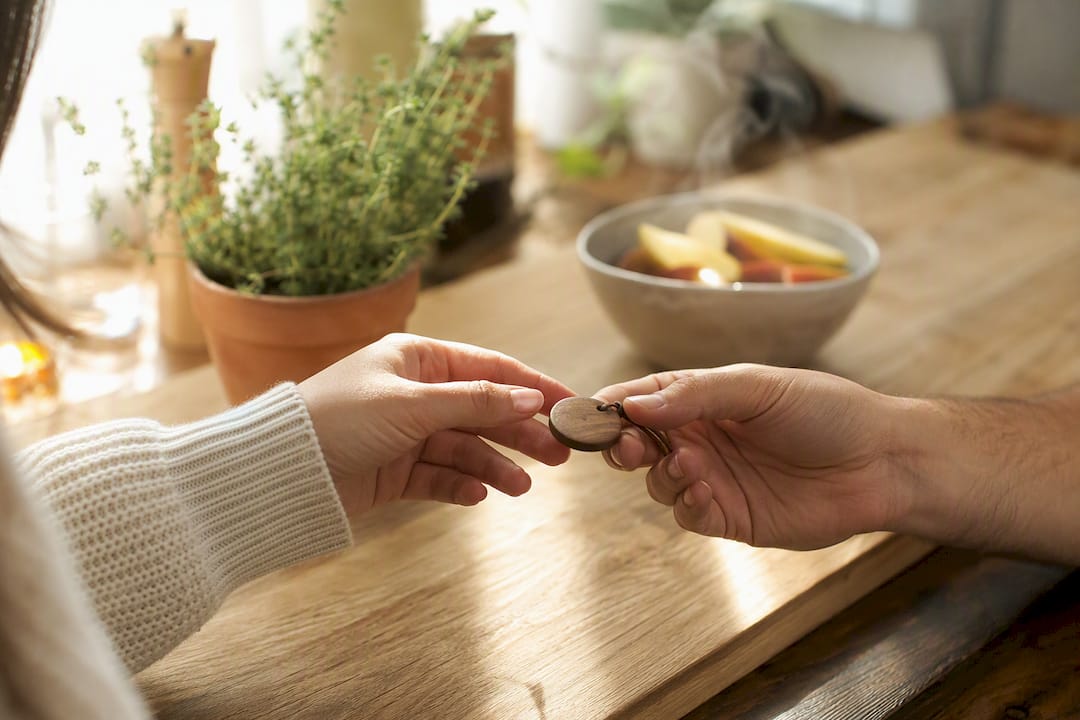 Hands exchanging small affectionate gift