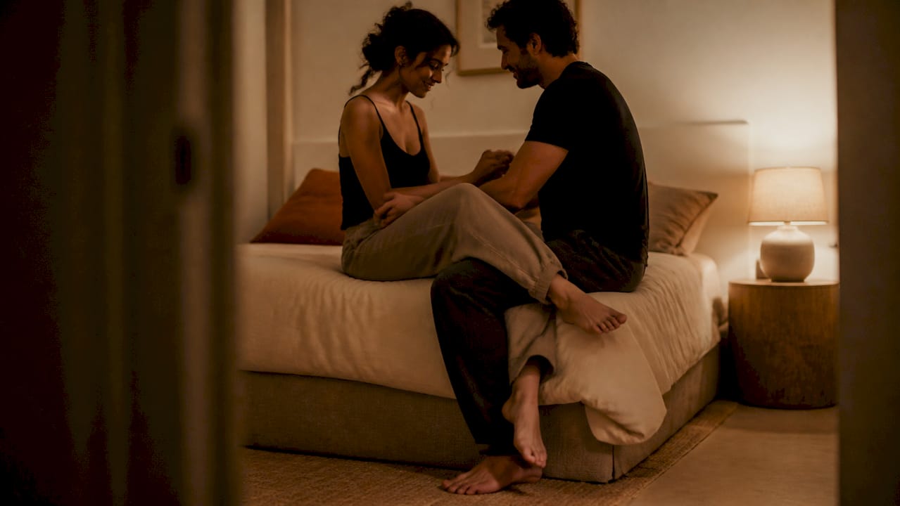Silhouetted couple exploring new bed position