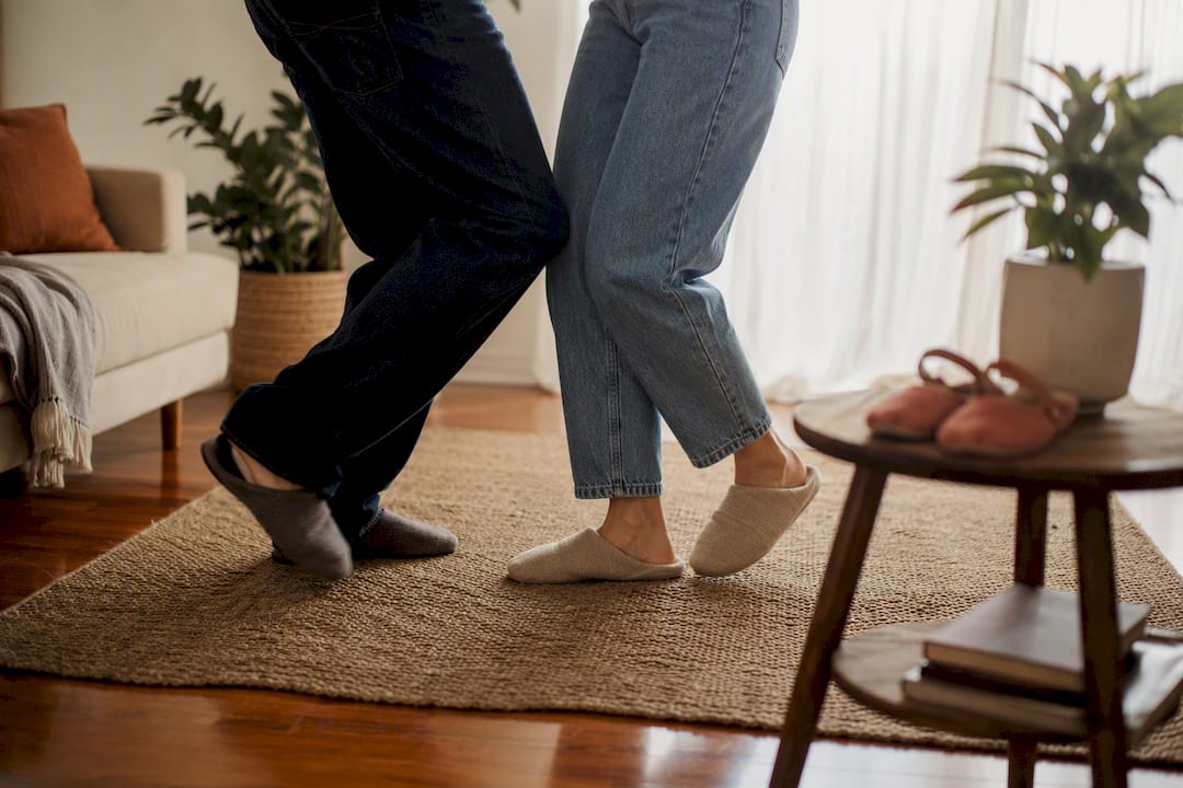 Couple’s feet practicing salsa dance indoors