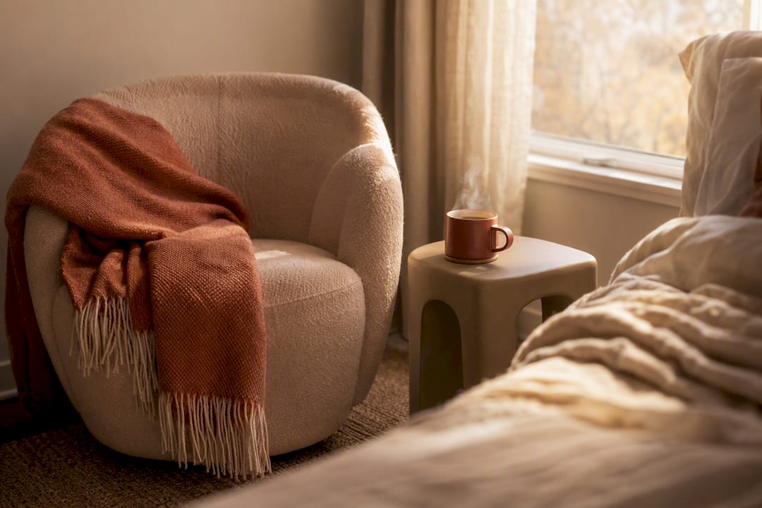 Cozy armchair with warm lighting bedside