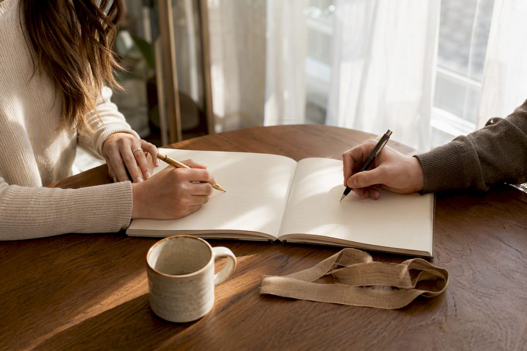 Two people adding entries to shared journal