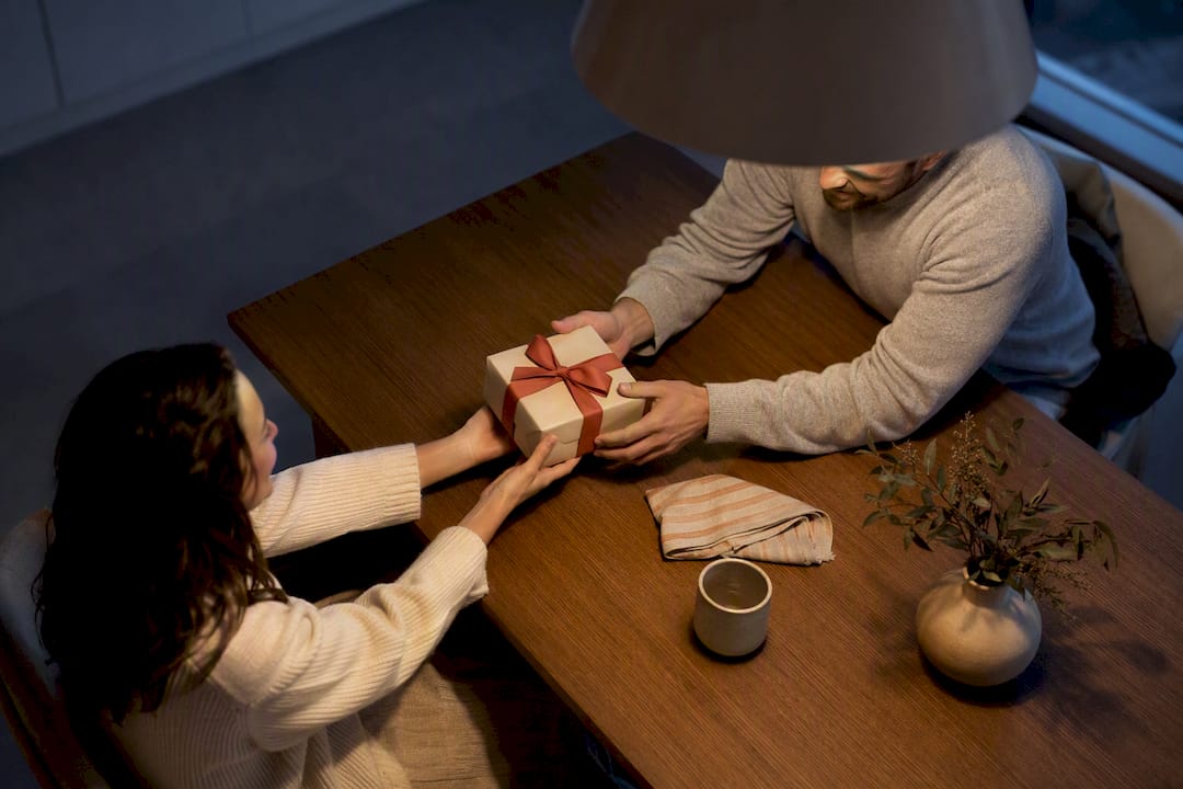 Couple exchanging a thoughtful wrapped gift