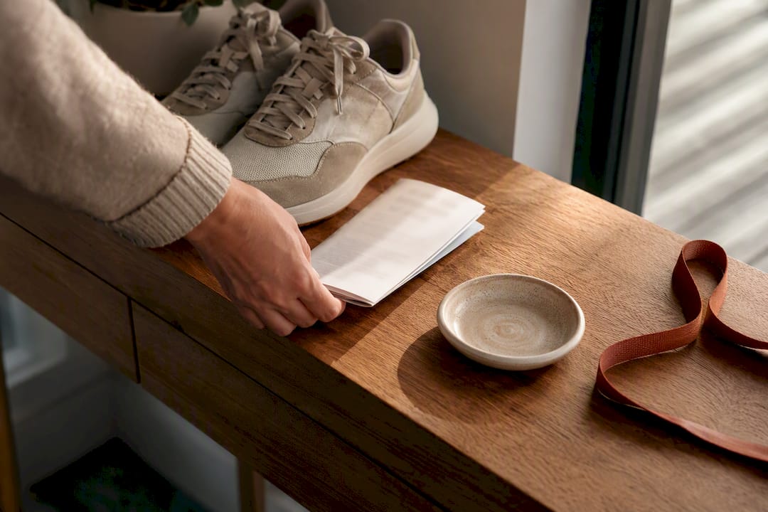 Folded date itinerary beside walking shoes