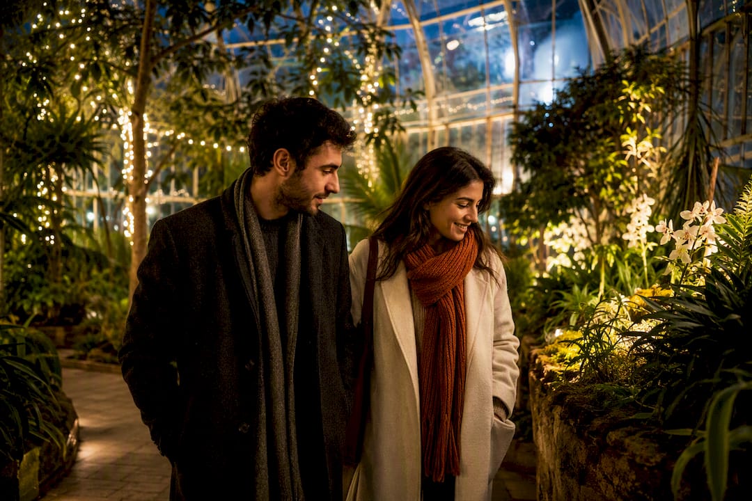 Couple walking through winter conservatory lights