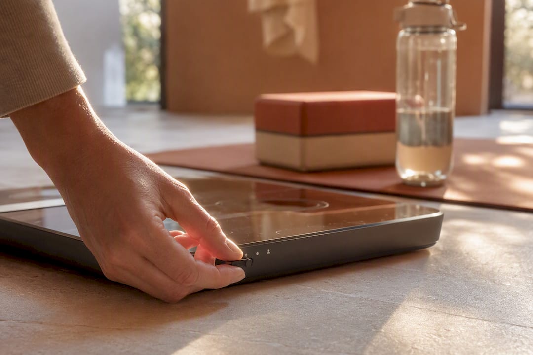 Hand adjusting pregnancy mode on smart scale