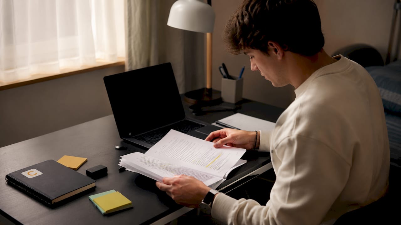 Hands organizing Turnitin file submission materials