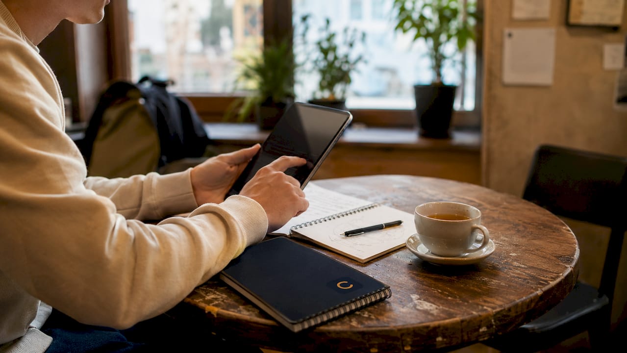 Close-up of student hands interacting with tablet
