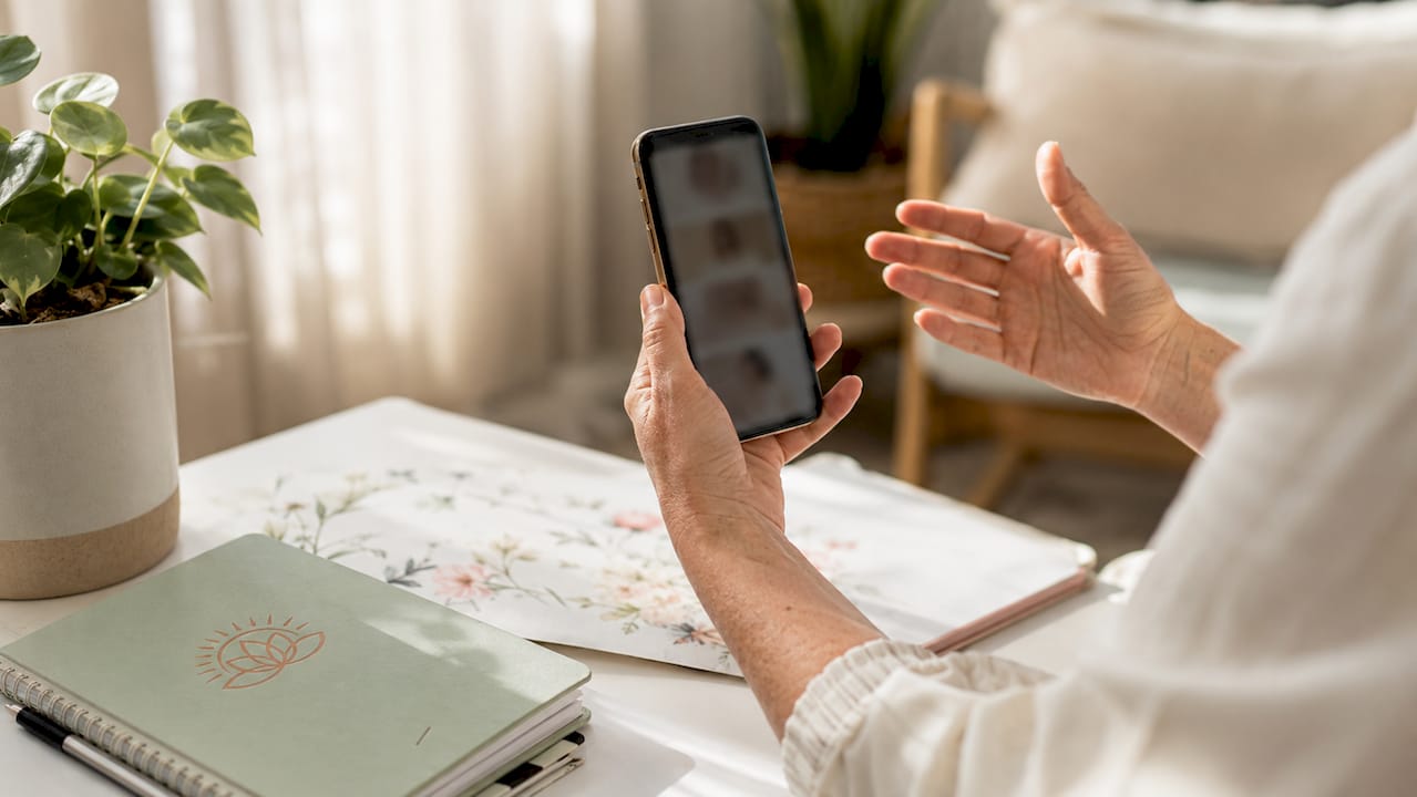 Hands showing skin diagnostic images on smartphone