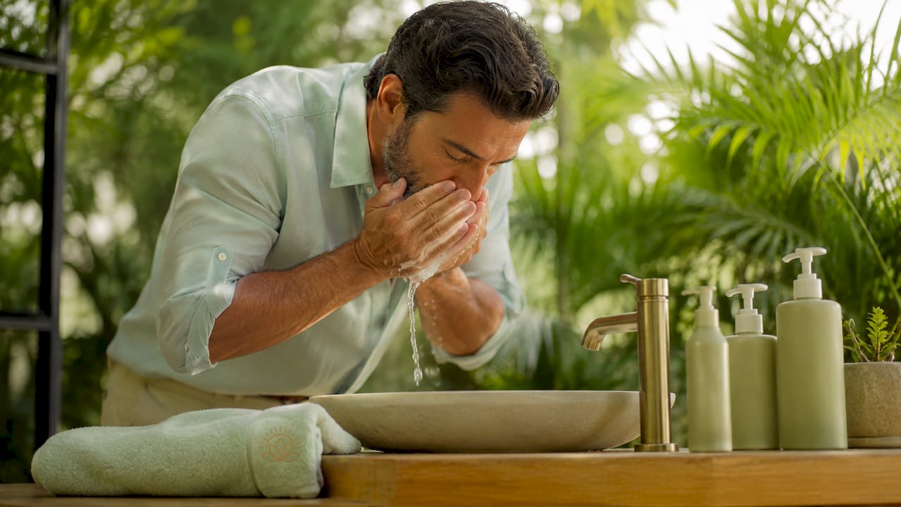 Man cleansing face with gentle cleanser
