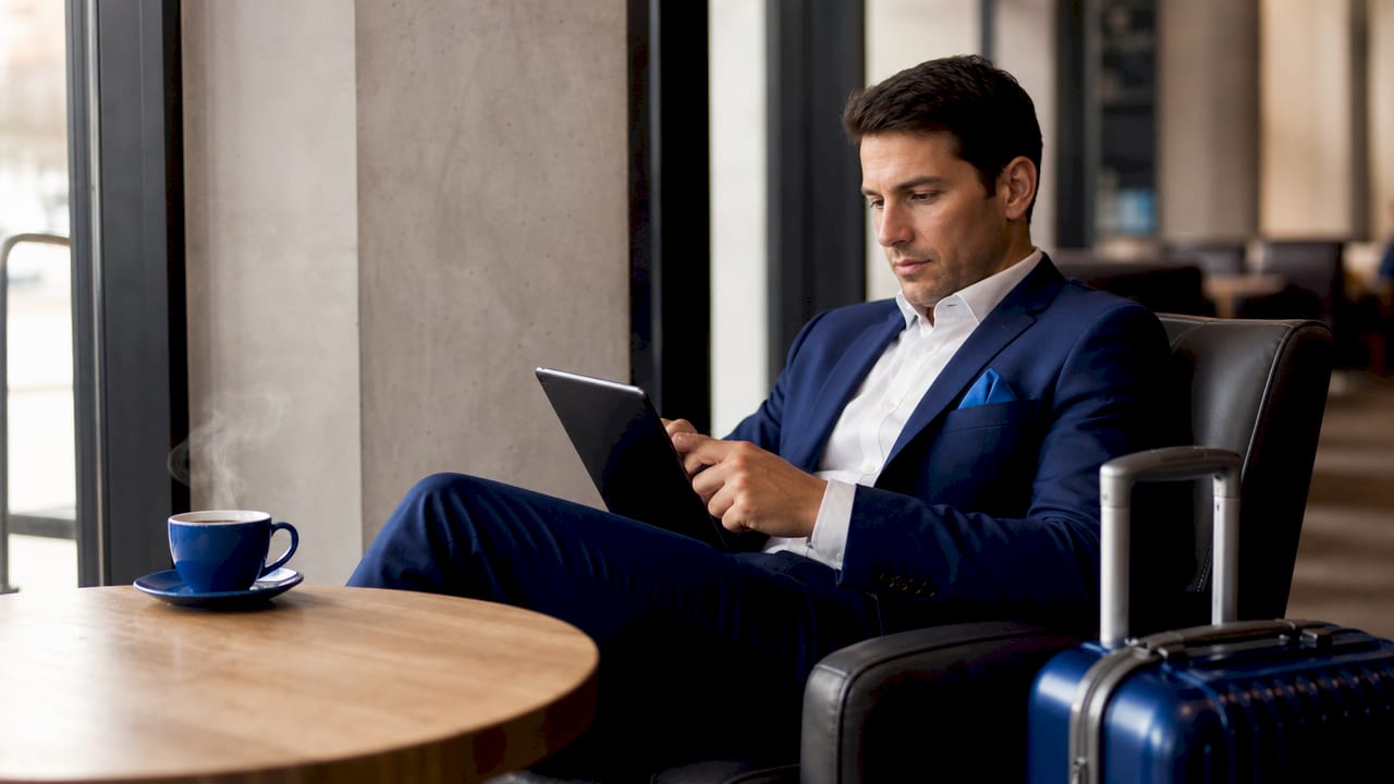 Corporate traveler checking jet route availability on tablet