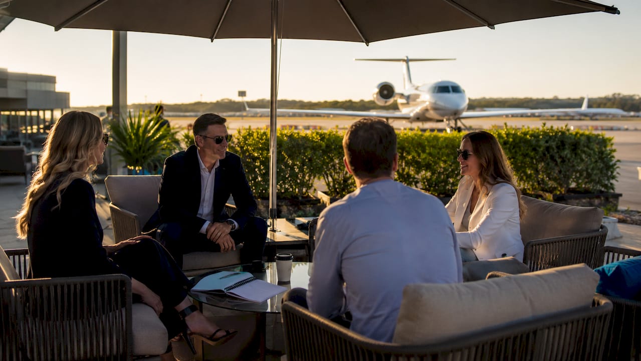 Business travelers relaxing in private terminal lounge