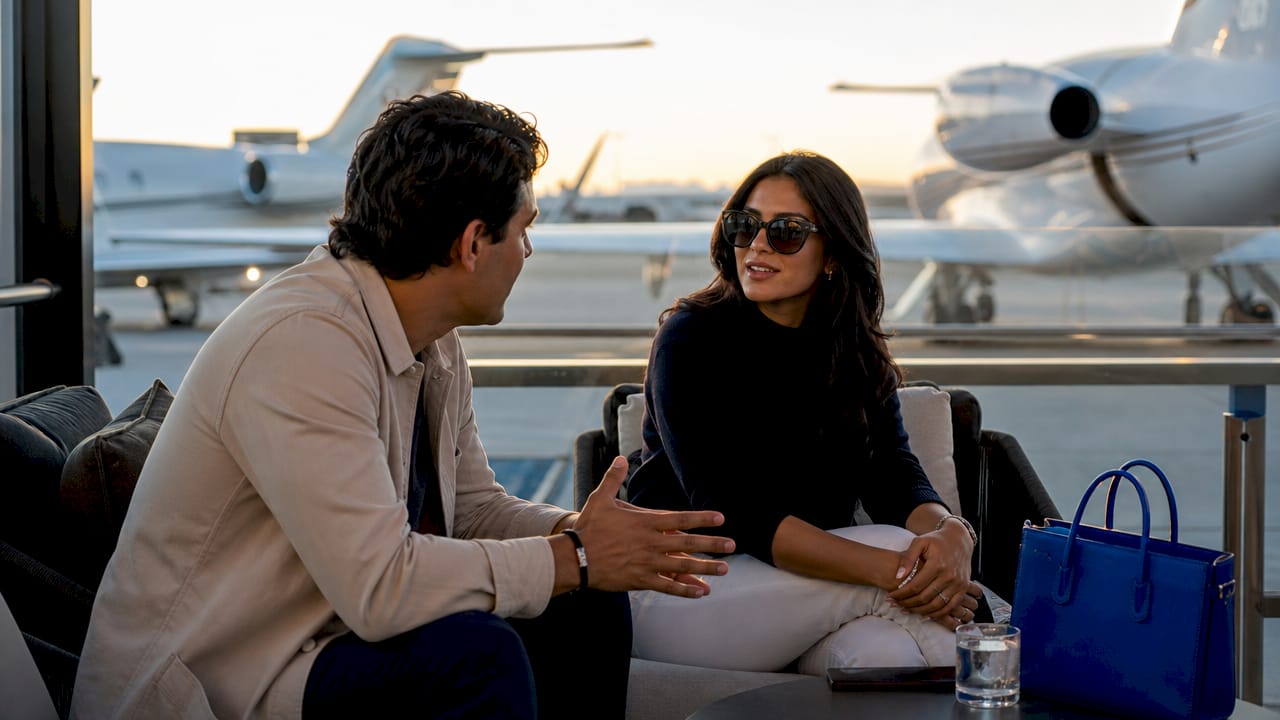 Travelers walking to parked private jets on tarmac