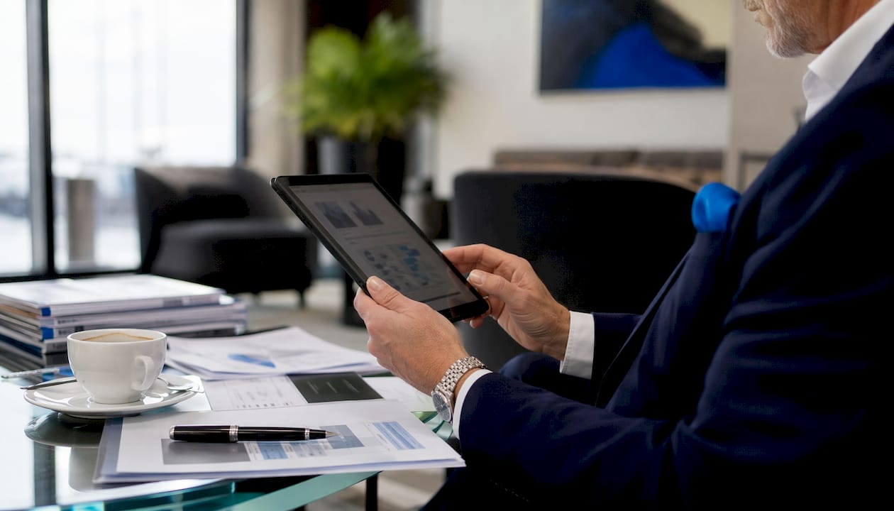 Executive reviewing private jet membership comparison documents