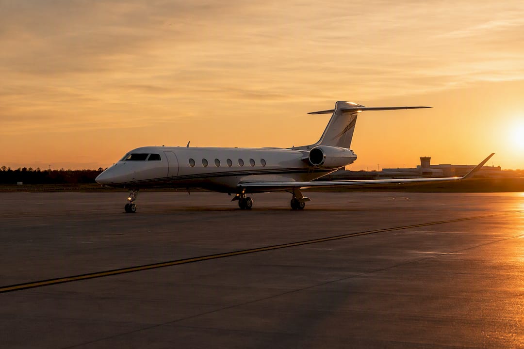 Empty private jet taxiing at sunset