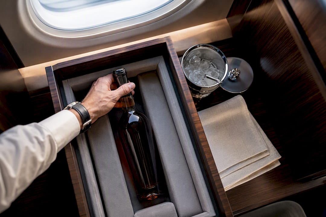 Bottle being placed in aircraft storage