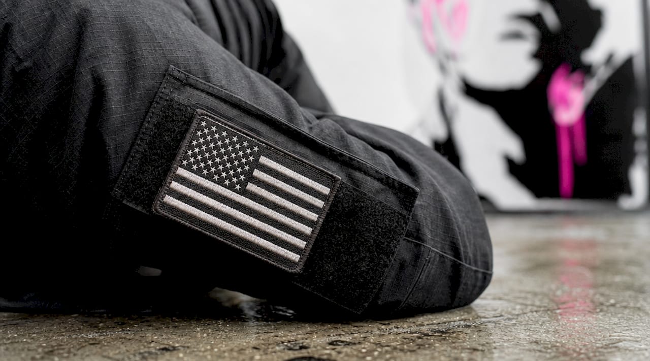 Close-up of American flag patch on camouflage sleeve