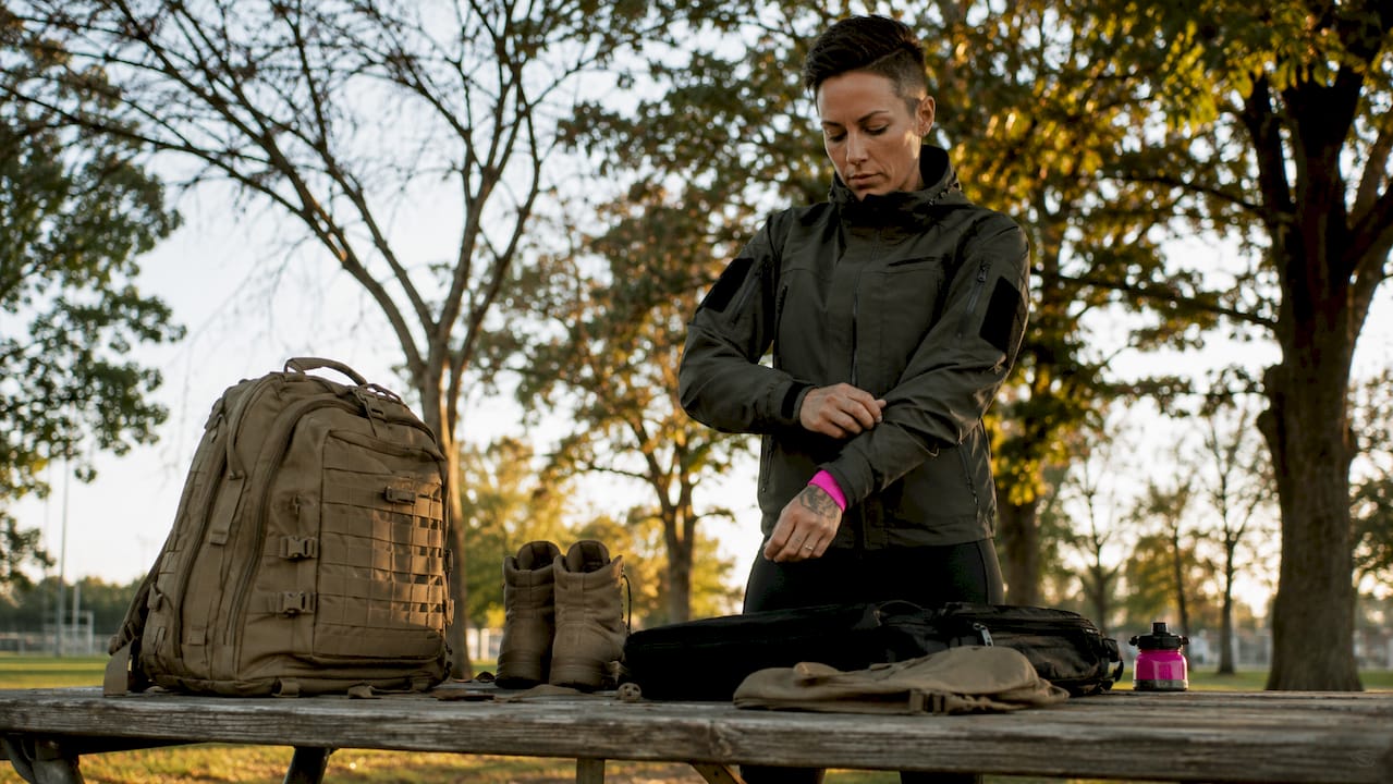Veteran adjusting tactical jacket outdoors