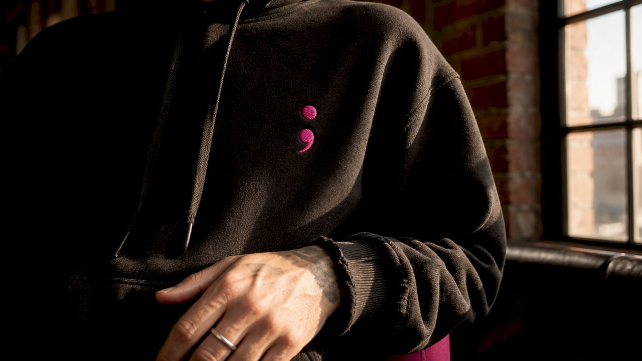 Close-up of semicolon symbol on PTSD awareness hoodie