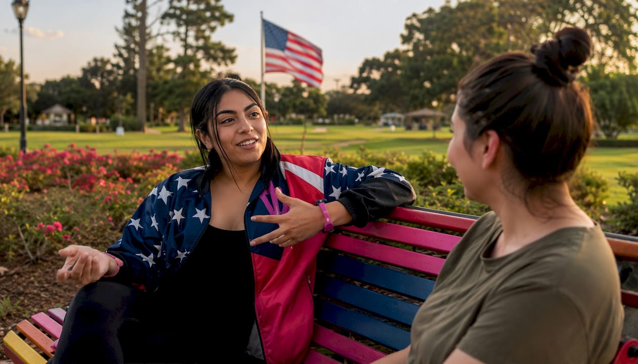 Veteran woman in patriotic apparel talking outdoors
