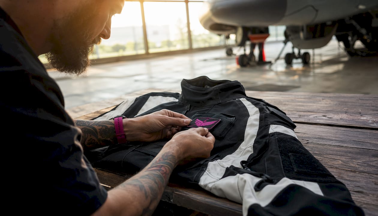 Close-up of hands inspecting military field jacket