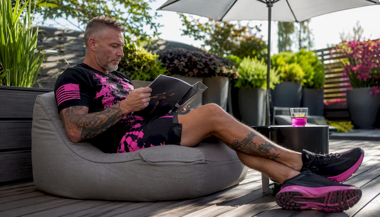 Man relaxing in home gym wearing veteran activewear