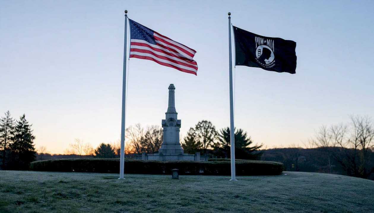 POW/MIA and U.S. flags flying together at memorial site
