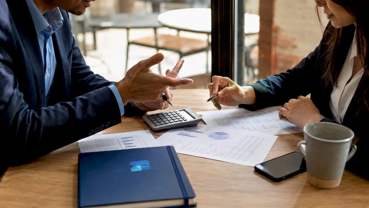Hands negotiating mid market earnout terms