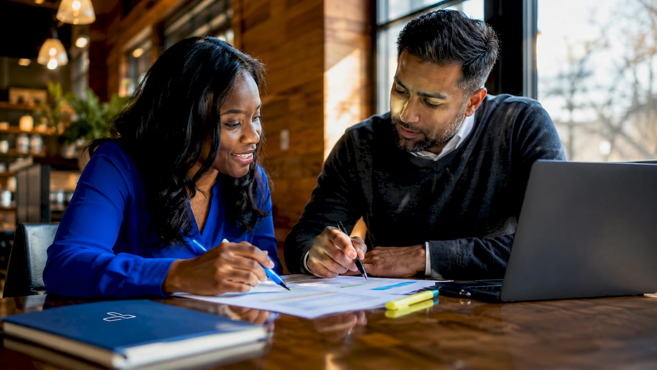 Professionals discussing bridge loan payoff schedule