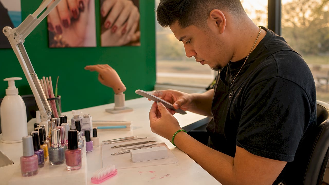 Hands practicing nail technician certification skills