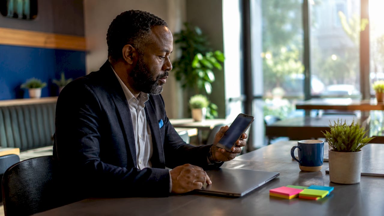 Man checking Teams mention notification in office