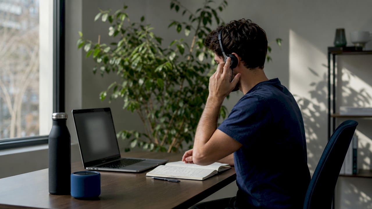 Person preparing for remote support huddle with headset