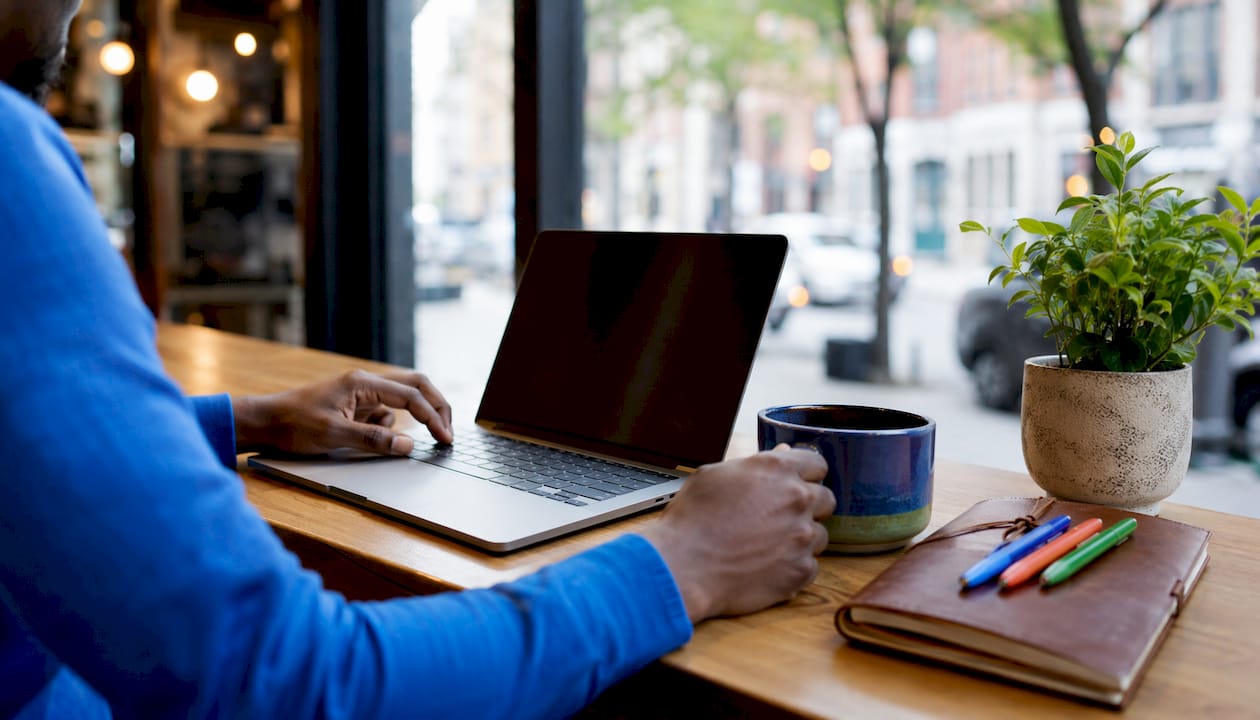 Hands configuring shared inbox on laptop