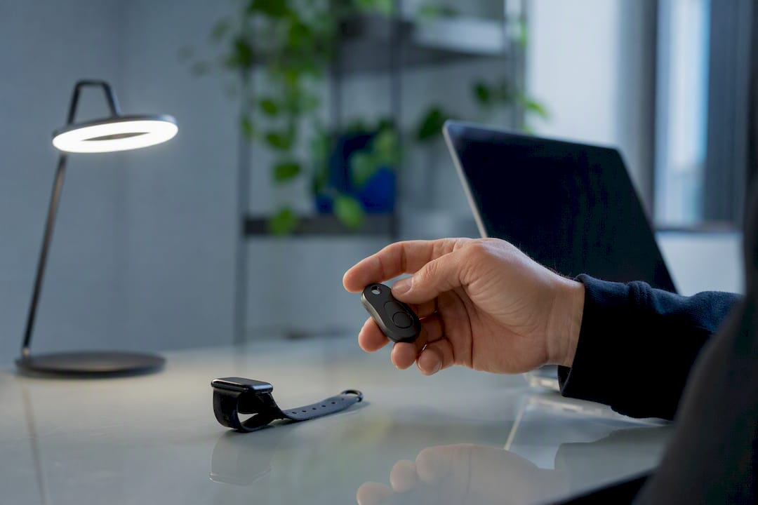 Hand holding security token on desk