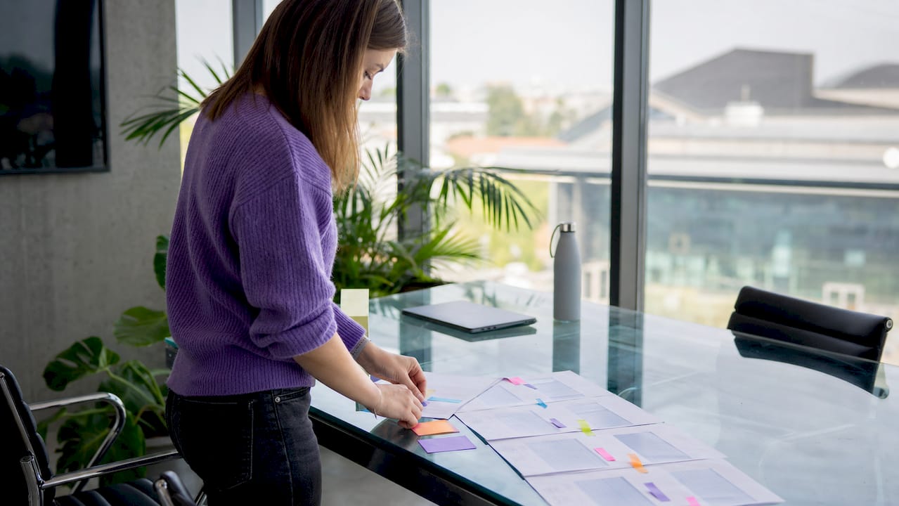 Hands organizing repetitive project tasks on table