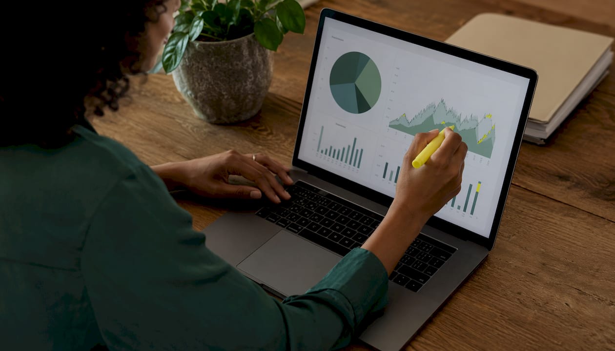 Hands marking email engagement statistics chart