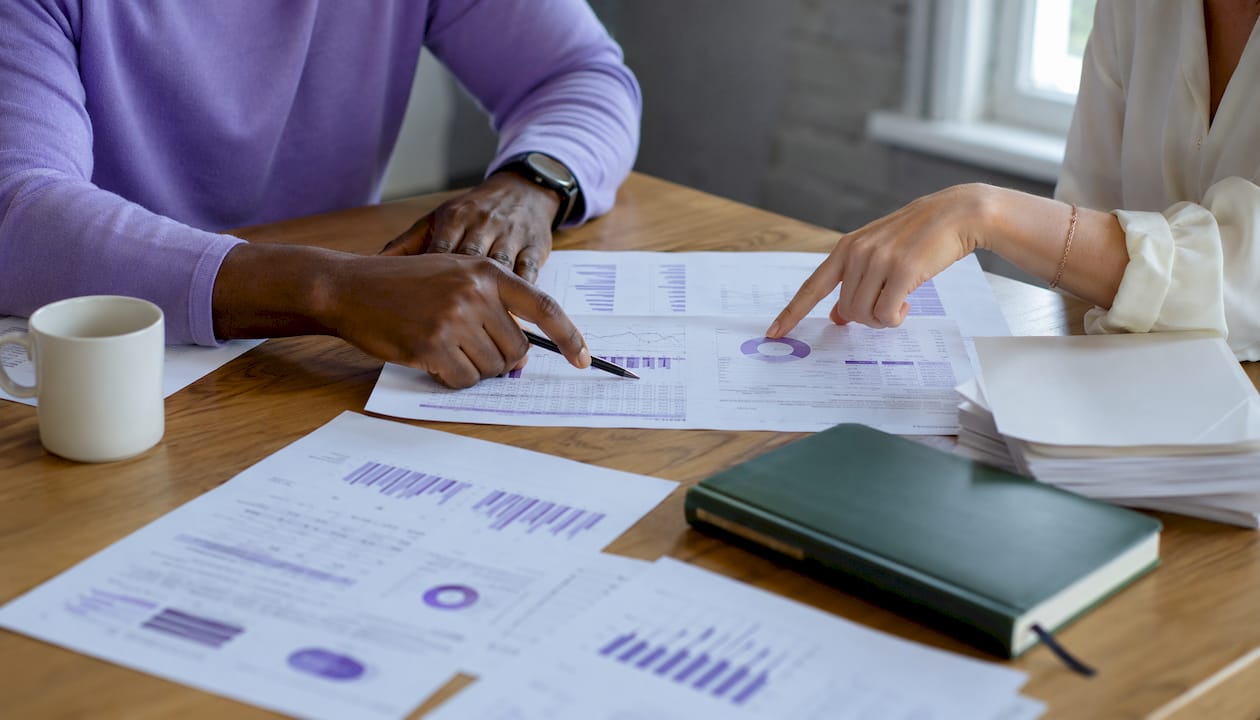 Hands analyzing workflow usage reports on desk